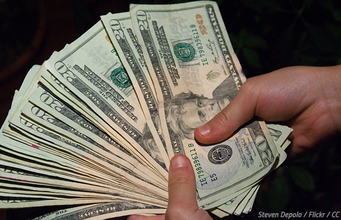 man holding physical cash money.